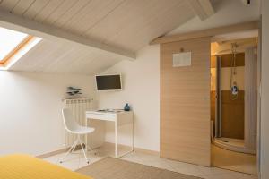 a room with a desk and a chair and a window at Civico 64 Bed & Breakfast in mansarda in Palmi