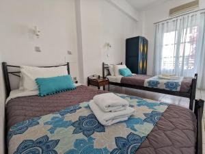 a bed in a bedroom with a white bedspread at Sea of Aegeon in Fira
