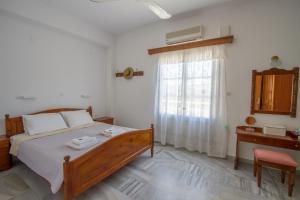A bed or beds in a room at Irene Hotel Leros