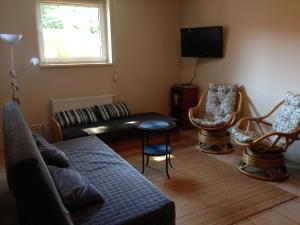 a living room with a couch and chairs at Pestka in Jastarnia