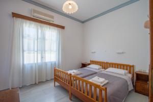 A bed or beds in a room at Irene Hotel Leros