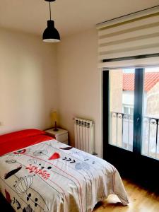 a bedroom with a bed and a large window at Vergarillas 2 in Ávila