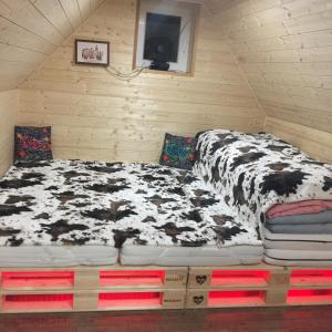 A bed or beds in a room at Pod lesem