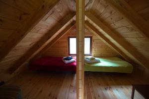 a room with two beds in a attic at Domek pod Klonem in Żary
