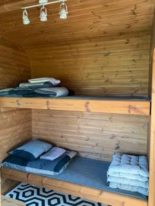 a wooden cabin with two bunk beds in it at Labrags Saulrieti in Jūrkalne