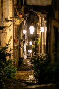 an alley in an old town at night at Rooms Epidaurus in Dubrovnik