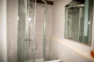 a shower in a bathroom with a glass shower backdoor at Rooms Epidaurus in Dubrovnik +7 photos