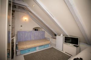 a small room with a bed and a tv at Rooms Epidaurus in Dubrovnik