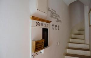 a room with stairs and a sign on the wall at Guest House Cittadella rooms in Dubrovnik