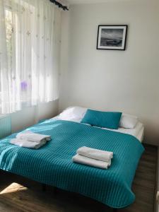Posteľ alebo postele v izbe v ubytovaní Karwia Pokoje & Apartamenty