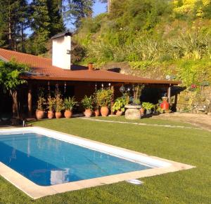 a swimming pool in the yard of a house at Casa Dos Canais, River Cottage in Marco de Canaveses