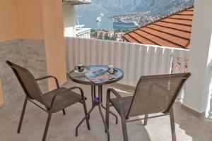 a table and chairs on a balcony with a view at Apartment Kalle in Kotor