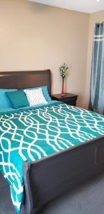 a bedroom with a bed with a blue and white bedspread at Cozy Condo in Houston +11 photos