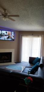 a living room with a couch and a flat screen tv at Cozy Condo in Houston