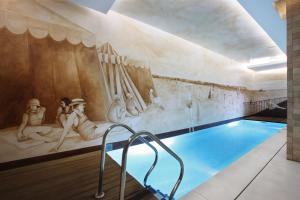 a swimming pool with a mural on the wall at Heritage Avenida Liberdade - Lisbon Heritage Collection - Avenida in Lisbon
