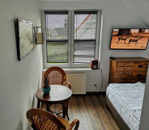 - une chambre avec une table, des chaises et un lit dans l'établissement Villa Watamu, à Trzęsacz