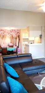 a living room with a couch and a wall with a painting at Cozy Condo in Houston