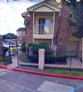 a house with a wrought iron fence in front of it at Cozy Condo in Houston
