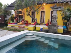 a house with a swimming pool in front of a house at Bali Fab Dive Center in Amed