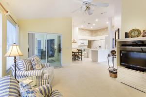 a living room with a couch and a tv at Serene & Attractive Heated Pool Spa Home in Estero