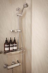 a shower with two bottles on a shelf in a bathroom at Hotel Lumia Myeongdong in Seoul