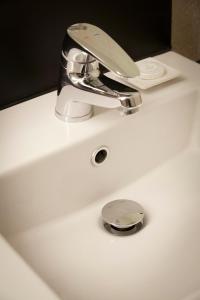 a bathroom sink with a chrome faucet on it at Hotel Lumia Myeongdong in Seoul +55 photos