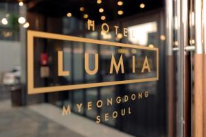 a window of a store with the words lumemite on it at Hotel Lumia Myeongdong in Seoul