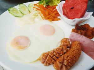 a plate of breakfast food with eggs and vegetables at Rock and Tree House Resort in Khao Sok National Park