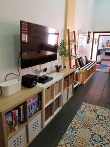 a living room with a flat screen tv on a entertainment center at Home@KKB in Kuala Kubu Baharu