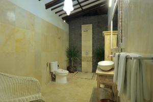 a bathroom with a toilet and a sink at Puri Mas Boutique Resort & Spa in Senggigi