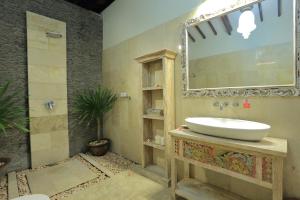 a bathroom with a sink and a mirror at Puri Mas Boutique Resort & Spa in Senggigi