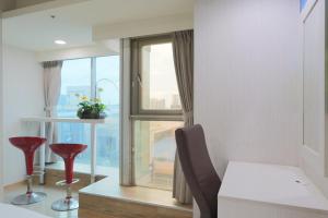 uma cozinha com uma janela, uma mesa e cadeiras em E Lim Hotel em Zhongli