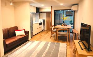 a living room with a couch and a table at NAOUMI HOUSE in Kanazawa