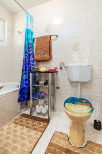 a bathroom with a toilet and a bath tub at Vacation House "Andy" in Pula