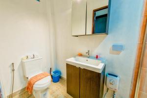 a bathroom with a white toilet and a sink at Thai Orange Villas in Jomtien Beach +36 photos
