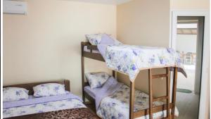 a room with two bunk beds in a room at Mirage Hotel in Zatoka