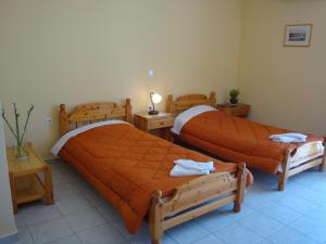 two beds in a room with two tables at Stamatia Studios in Razáta