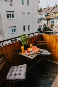 a table with food and drinks on a balcony at Apartment Budacenter in Budapest