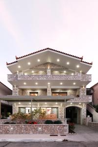 a large house with a stone facade at Villas Ve in Tiros