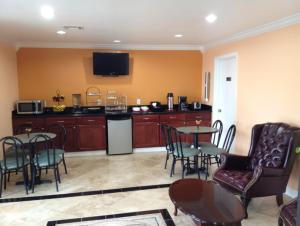 a living room with a kitchen with a table and chairs at Executive Inn and Suites Houston in Houston