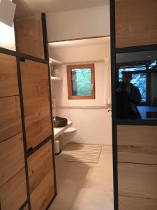 une salle de bain avec des armoires en bois et une fenêtre dans l'établissement Rustico Berlinda, à Bironico