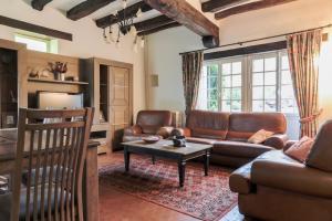 a living room with a couch and a table at Picturesque country house - Le Mini Vau in Continvoir