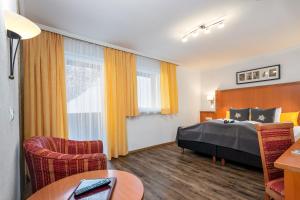 Postel nebo postele na pokoji v ubytování Hotel Das Schlossberg superior