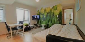 a bedroom with a bed and a mural of flowers at Scandian Apartments - City Park Tallinn in Tallinn
