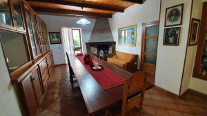 a living room with a table and a fireplace at Villa Canu in Alghero