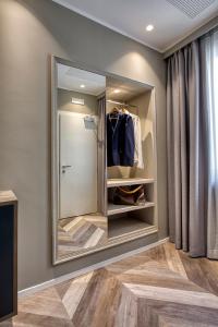 a walk in shower in a bathroom with a mirror at Italianflat - Design rooms Verona in Verona