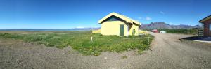 a small house on the side of a road at Guesthouse Hof in Hofgarðar