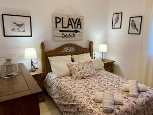 a bedroom with a bed with two pillows on it at Casa Maldo in Tarifa