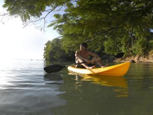 
a man paddling a canoe in the middle of a lake at Grand Palladium Jamaica Resort & Spa All Inclusive in Lucea
