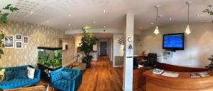 a living room with blue furniture and a fish tank at Hotel Le Relais Saint-Jacques in Saint-Jean-de-Luz